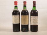 trois bouteilles de vin sont alignées sur une surface blanche