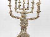 an antique brass menorah with five candles on a marble base