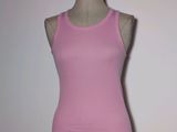 a female mannequin wearing a pink tank top on a mannequin stand