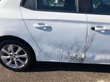 a white car that has a lot of dirt on the side of it