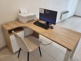 a desk with a computer, printer, and printer on it