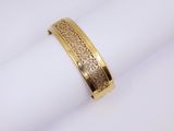 a close up of a gold ring on top of a napkin