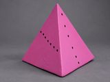 a pink paper pyramid with holes in the middle