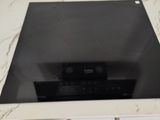 a black stove top on a marble counter top