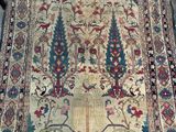 a large oriental rug on display in a room