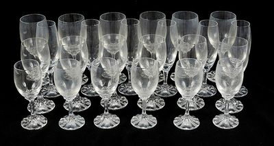 a lot of wine glasses that are lined up together