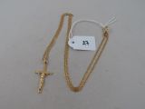 a close up of a cross and a chain on a table