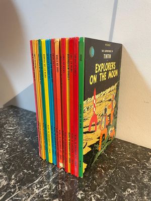 a stack of children ' s books sitting on top of a table