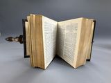 an open book sitting on top of a table next to a knife