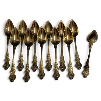 a lot of spoons that are lined up on the table