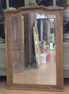 a mirror that is sitting on the floor in front of a dresser