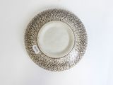 a white plate with a black and white design on it