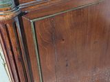 a wooden cabinet that has a clock on top of it