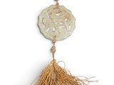 a close up of a tassel hanging on a white wall