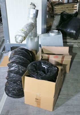 many bags of garbage sitting on the floor next to boxes