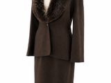 a woman ' s coat with a fur collar on a mannequin