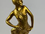 bronze statue of a woman in a dress on a marble base