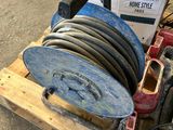 a stack of hoses and a reel on a pallet