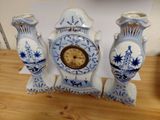 three blue and white vases sitting on a wooden table