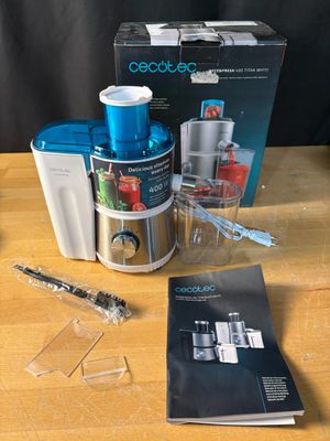 a blender and a book sitting on a table