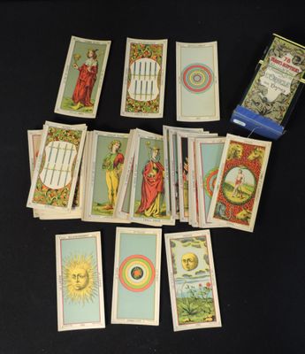 a lot of tarot cards that are on the table