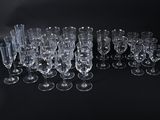 a lot of empty wine glasses on a black table