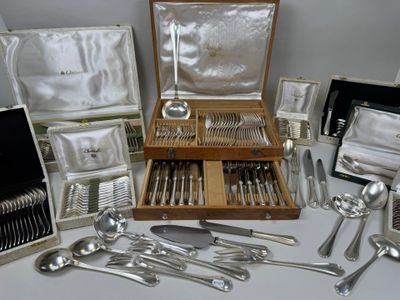 a lot of silverware in a case on a table
