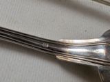 a silver spoon and a spoon rest on a table