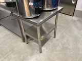 two large pots sitting on a table in the kitchen