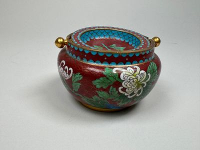 un vase rouge et bleu orné de fleurs