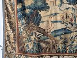 a tapestry hanging on a wall in a room