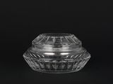 a close up of a clear glass container on a black background