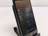 a cell phone that is sitting on top of a stand