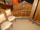 three chairs and a bed in a room with a mirror