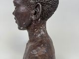 an image of a statue of a young boy with a black head