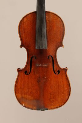 an old violin with a bow hanging from it ' s back