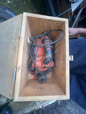 a box with a drill and a cord in it