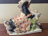 a figurine of a woman and a dog on a table