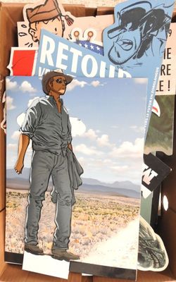a cardboard box filled with magazines and a drawing of a cowboy