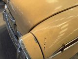 a close up of a car ' s front end with rust on it
