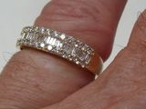 a woman ' s hand with a diamond ring on it