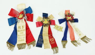 three ribbons with ribbons on them are tied together on a white surface