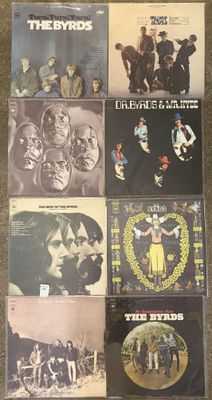 the byrds album covers on a carpeted floor