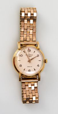 an image of a close up of a wrist watch on a white surface