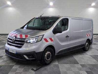 a silver van with red stripes parked in a room