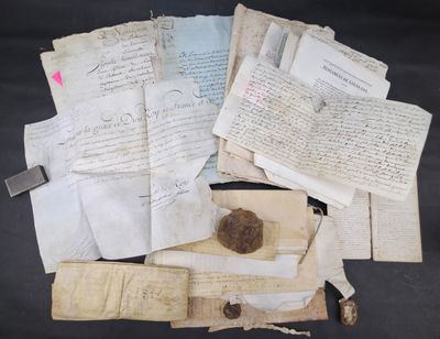 some old papers and a rock on a black surface