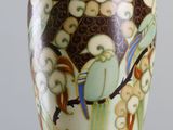 a vase that has a bird design on it