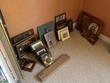 a room with a lot of pictures and pictures on the floor