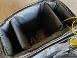 a bag with a cell phone in it on the floor