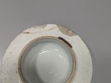 a white cup and saucer sitting on a table